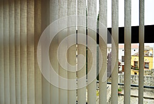 Blinds with adjustable vertical slats made of fireproof fabric to regulate ambient light