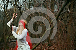 Blinfolded woman in forest