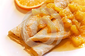 Blini with oranges in sweet sauce photo