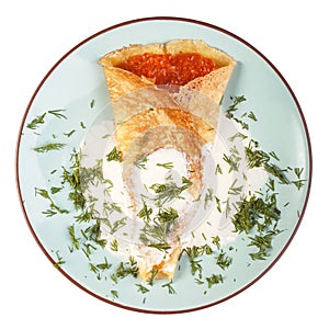 Blini with red caviar and dill on a plate