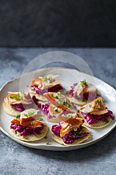 Blinis with creamy beetroot, goat cheese and hot smoked salmon