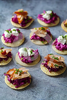 Blinis with creamy beetroot, goat cheese and hot smoked salmon