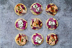 Blinis with creamy beetroot, goat cheese and hot smoked salmon