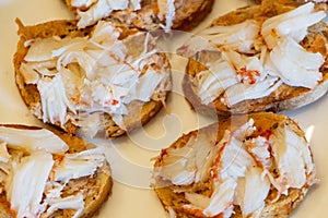 Blinis with lobster pieces