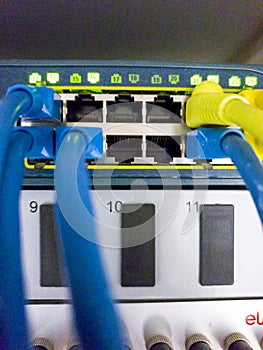 Blinking network ethernet active switch with connected cables in server room