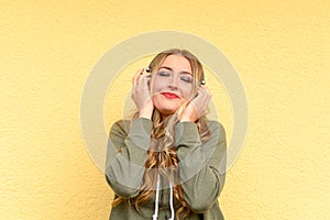 Blissful pretty blond woman listening to music