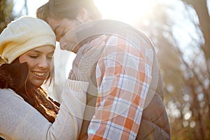 Blissful romance...A loving young couple being affectionate while standing together in the outdoors.