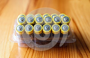Blister pack of AA LR6 1.5V alkaline batteries on wooden table