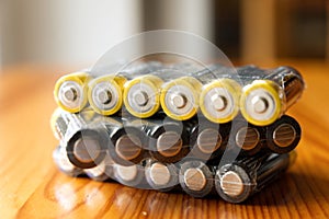 Blister pack of AA LR6 1.5V alkaline batteries on wooden table