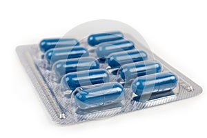 Blister pack with blue pills, close-up in selective focus