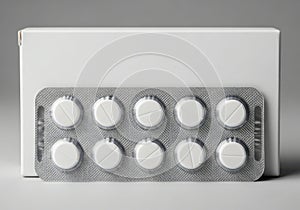 White round pills in blister pack with plain white box background