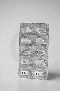 A blister pack of smiley pills. concept of drugs that bring happiness. antidepressants