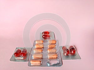 Blister of pills on pink background. medical concept