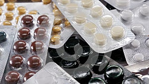 Blisters with medicines on the table. Medicinal components, capsules with granules of a medical preparation.