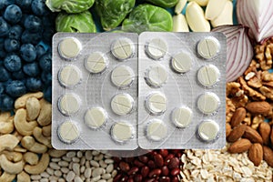 Blisters of pills on foodstuff, top view. Prebiotic supplements