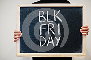 Blk fri day written on blackboard. Black friday concept. Boy hold board