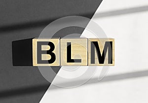 BLM acronym for Black Lives Matters movement. Abstract concept with gray-black and white parts