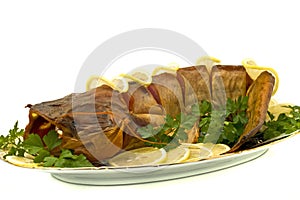 Bloated fresh-water catfish on the plate photo
