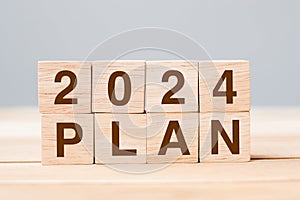 block 2024 PLAN text on table. Resolution, strategy, goal, motivation, reboot, business and New Year holiday concepts