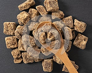 Block of brown sugar placed on a black background