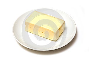 Block of butter on plate