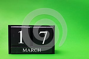 Block calendar for March 17 St Patrick's Day on green background