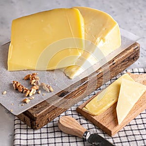 Block of cheese on a wooden cutting board