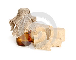 A block of compressed fresh yeast with pharmaceutical bottle.