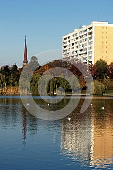 Block of flats and church with reflection 