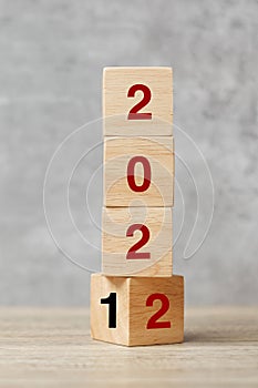 Block flipping 2021 to 2022 text on table. Resolution, strategy, plan, goal, motivation, reboot, business and New Year holiday