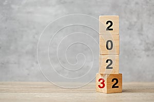 Block flipping 2022 to 2023 text on table. Resolution, strategy, plan, goal, motivation, reboot, business and New Year holiday