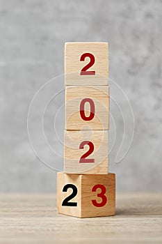 Block flipping 2022 to 2023 text on table. Resolution, strategy, plan, goal, motivation, reboot, business and New Year holiday