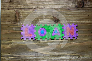 Block letters and word loan with wood background