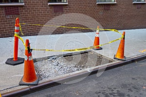 Block off sidewalk area with orange white reflective  cones and pole with yellow black caution tape