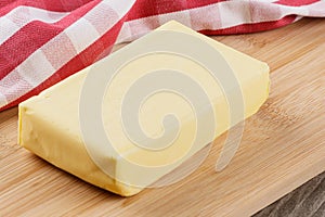 Block of Organtic butter islated on a wooden chopping board