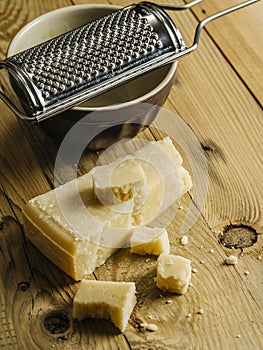 Block of parmesan cheese and grater