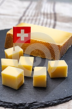 Block of Swiss medium-hard matured cheese gruyere used for baking, quiche, fondue, sandwiches