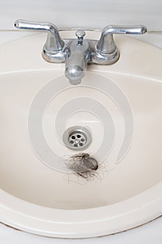 Blockage of bathroom sink with woman hair