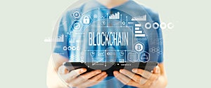 Blockchain theme with man using a tablet