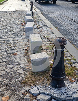 Blocked road concept. The road is blocked with concrete slabs and a chain. The passage is closed