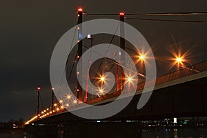 Blocked Theodor-Heuss Bridge in DÃ¼sseldorf at night with a lift truck for structural analysis