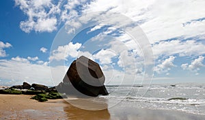 Blockhouse on the beach with blue sky and clouds