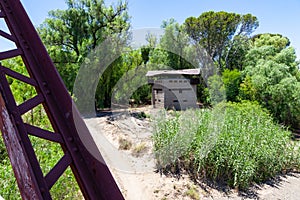 A blockhouse situated near a raliway crossing.