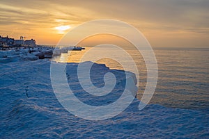 Blocks of ice on the seashore at sunset