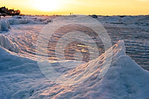 Blocks of ice on the seashore at sunset