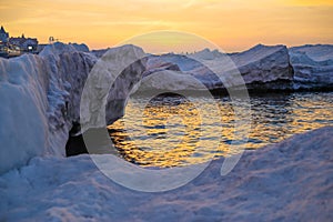 Blocks of ice on the seashore at sunset