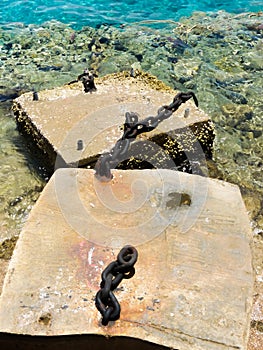 Blocks of the old harbor with chains.