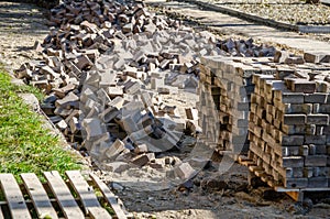 Blocks with paving slabs. Pavement repair and laying. Pile of paving stones for pavement repair