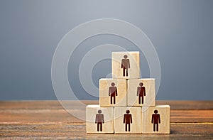 Blocks pyramid with people. Joint efforts to achieve goal. Teamwork, cooperation and collaboration. Team building, company