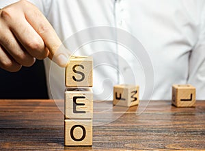 Blocks with the word SEO and businessman. Search Engine Optimization. Increase the quality and quantity of website traffic by